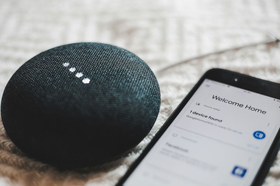 Smart speaker with phone showing device setup